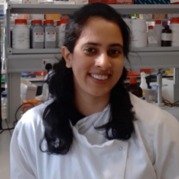 Tanya Singh in front of science bottles