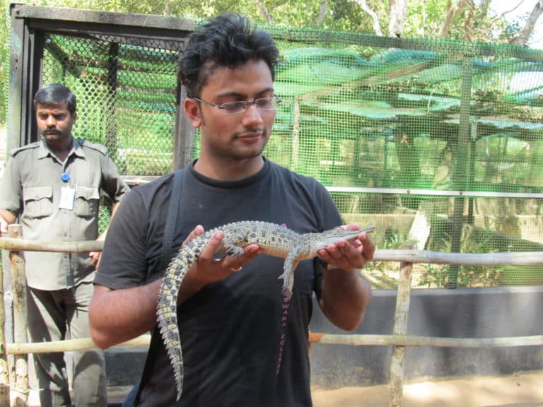 Nishant holding a baby crocodile